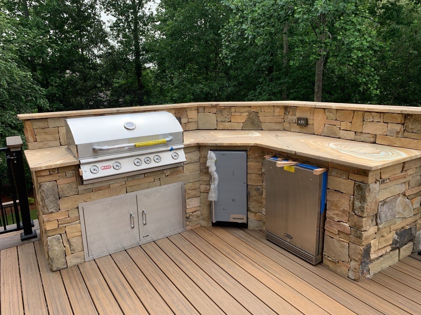 Luxury outdoor kitchen with stone island and built-in grill