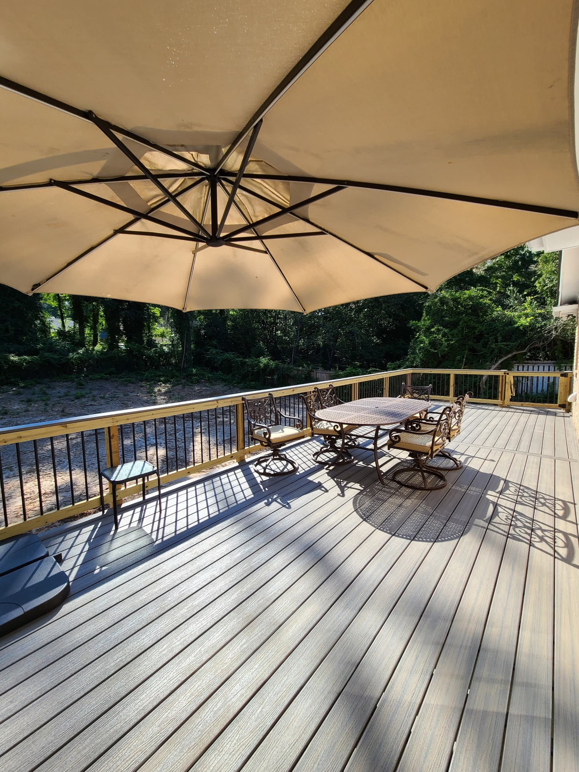 Large composite deck with dining area and umbrella