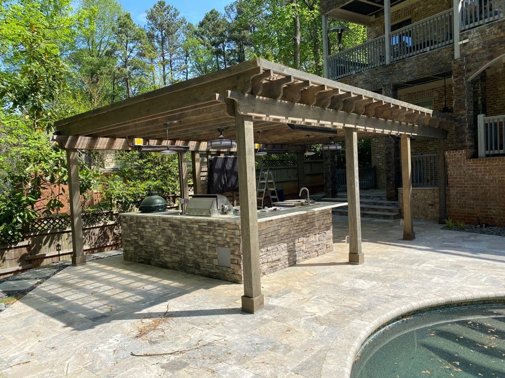 Large pergola over outdoor kitchen near pool