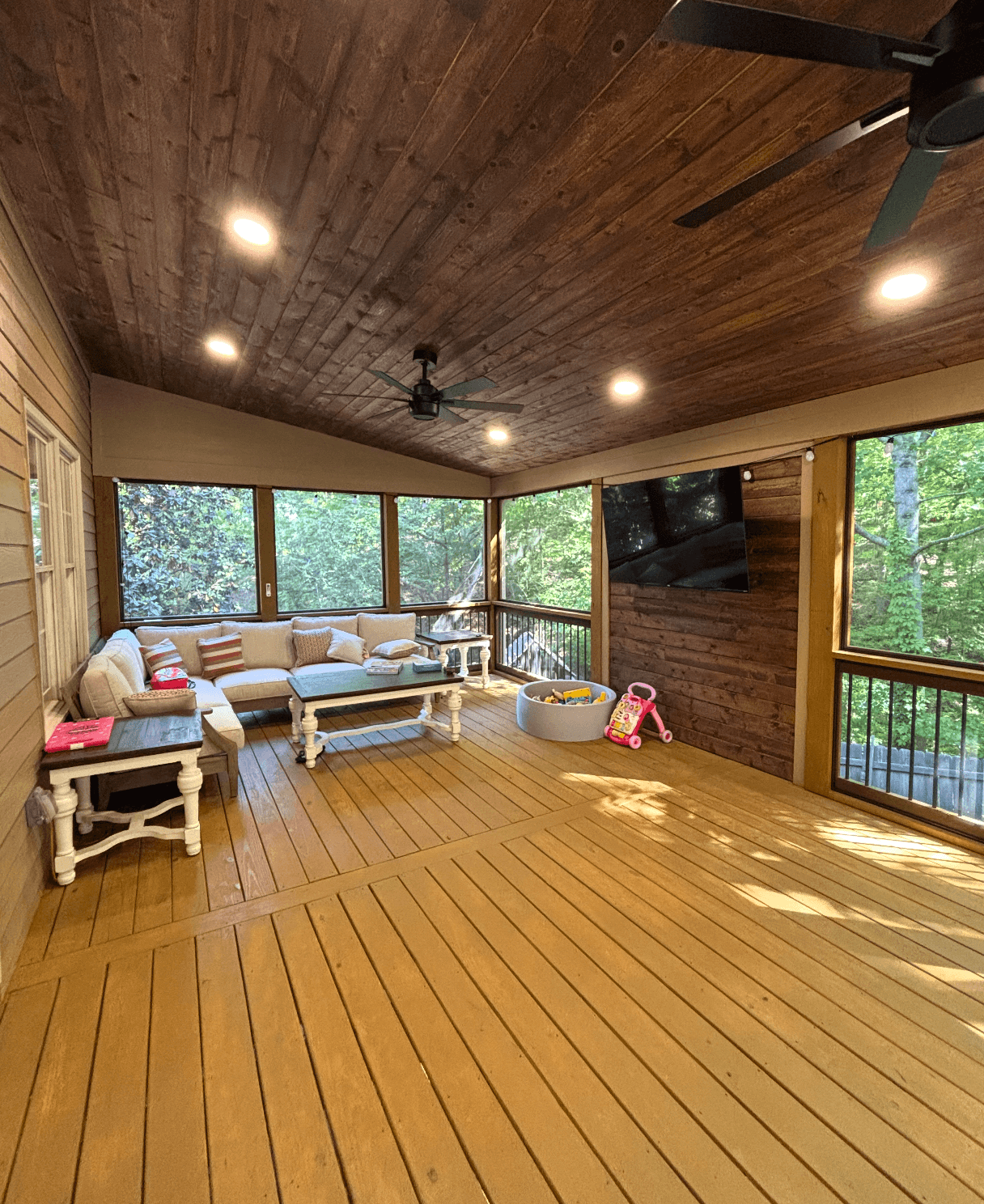 Luxurious screened porch with tongue-and-groove ceiling and sectional