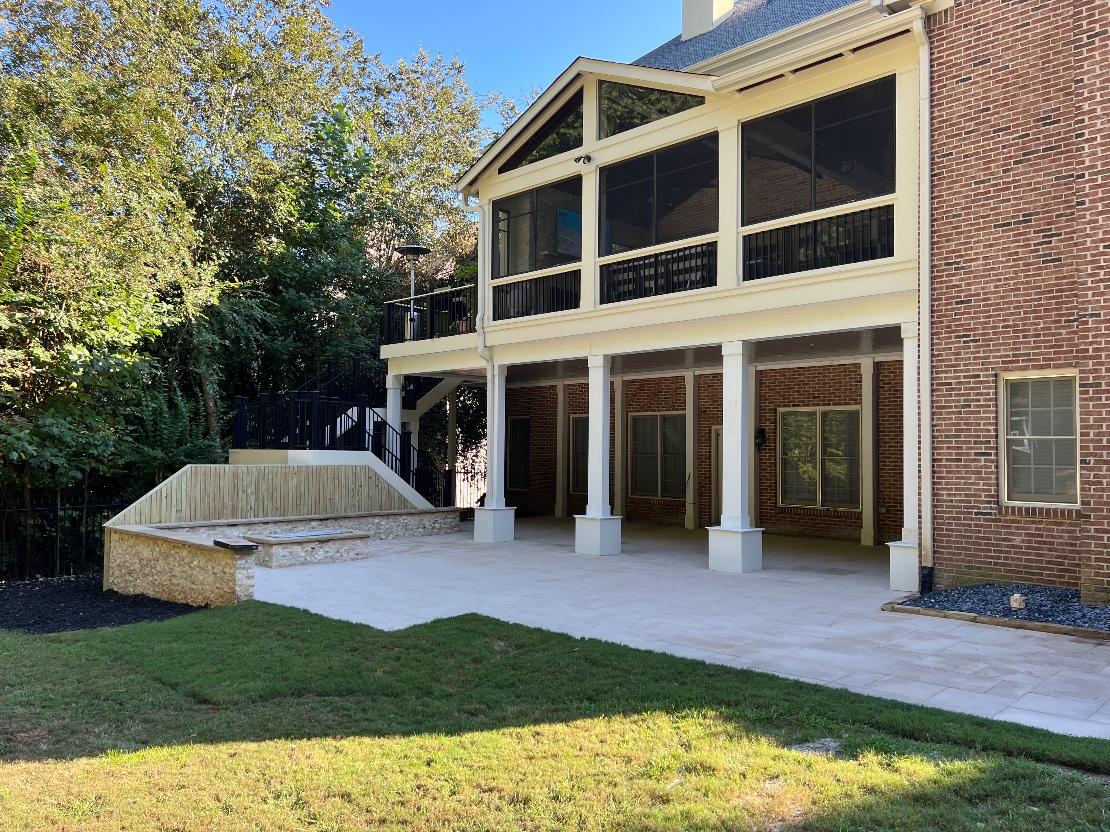 Two-story screened porch on brick home