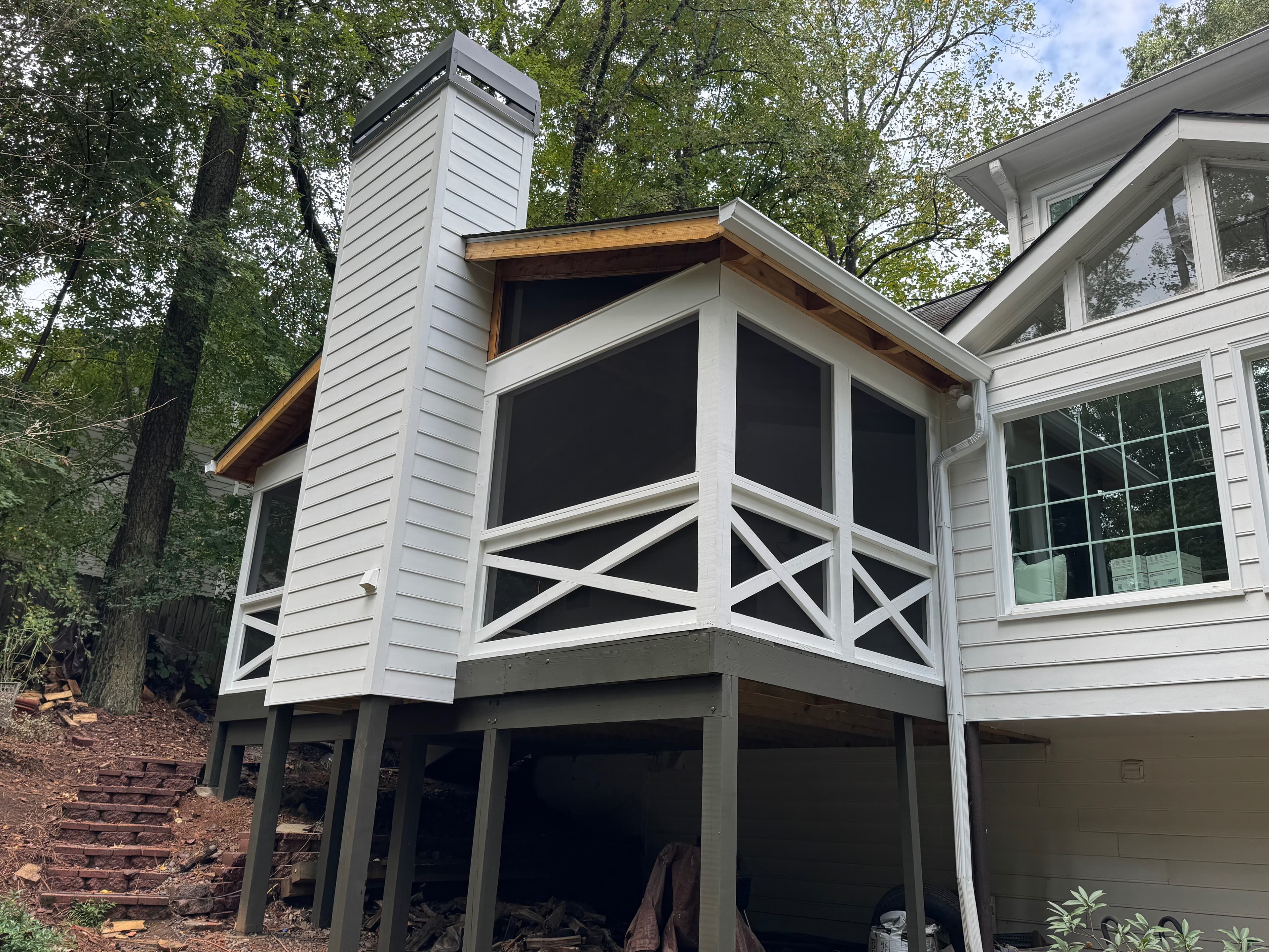 Elevated screened porch with X-pattern railings