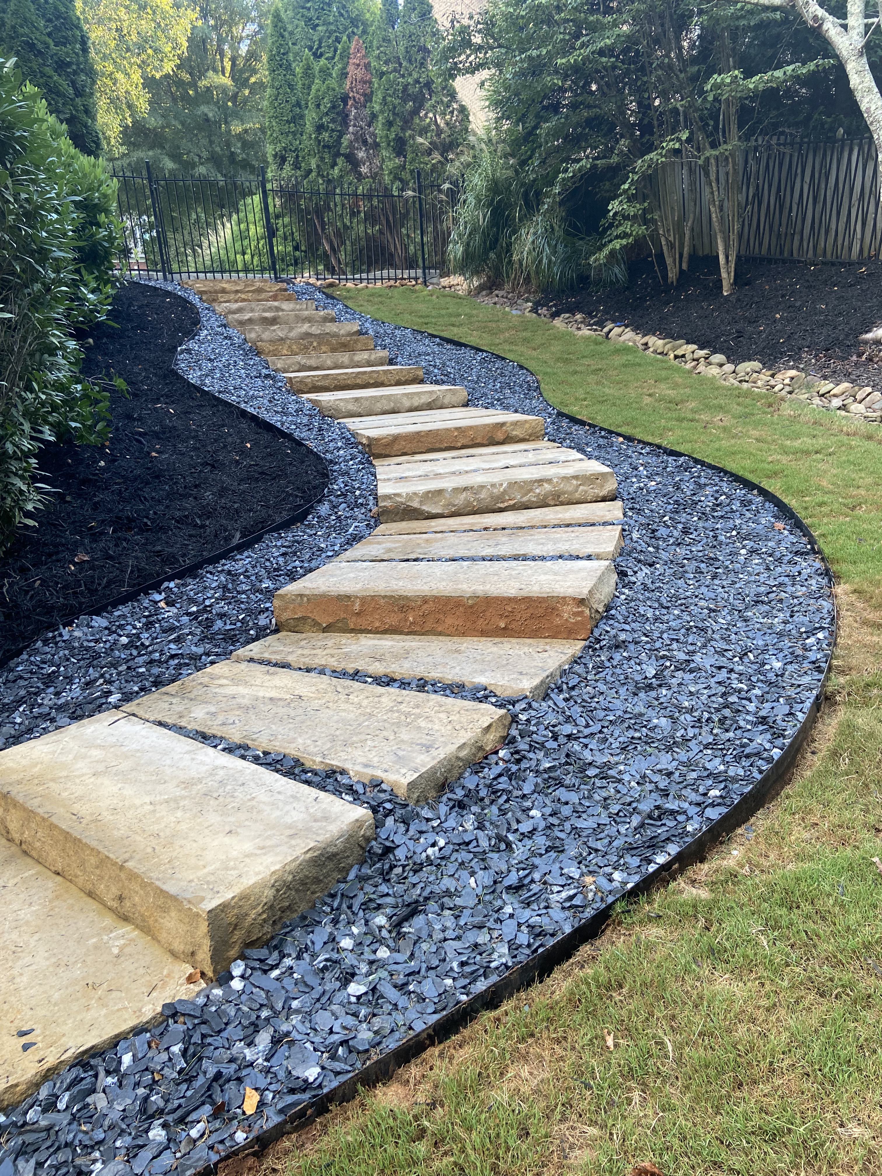 Winding stone path with blue slate gravel border