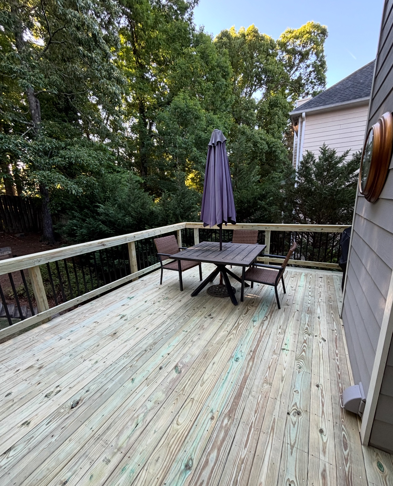 Large pressure-treated deck with outdoor dining furniture