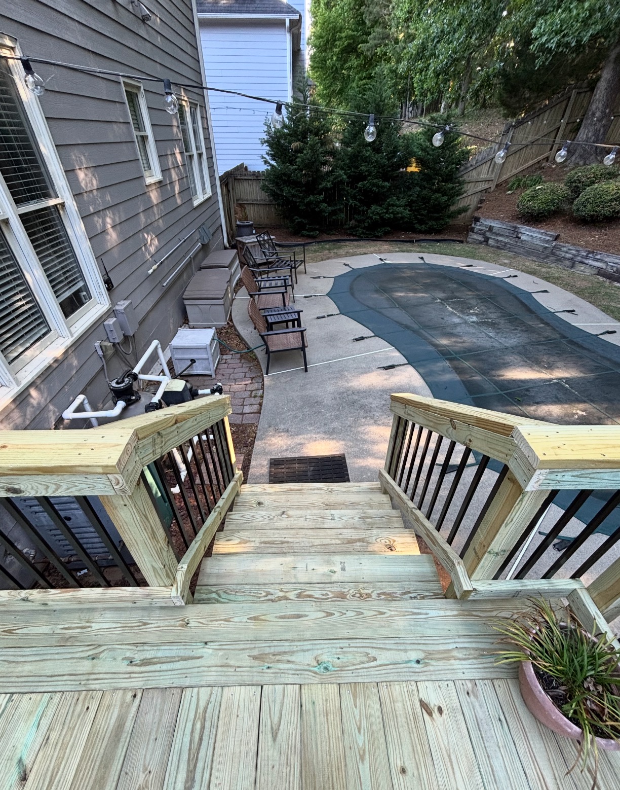 Pressure-treated deck stairs leading to pool area